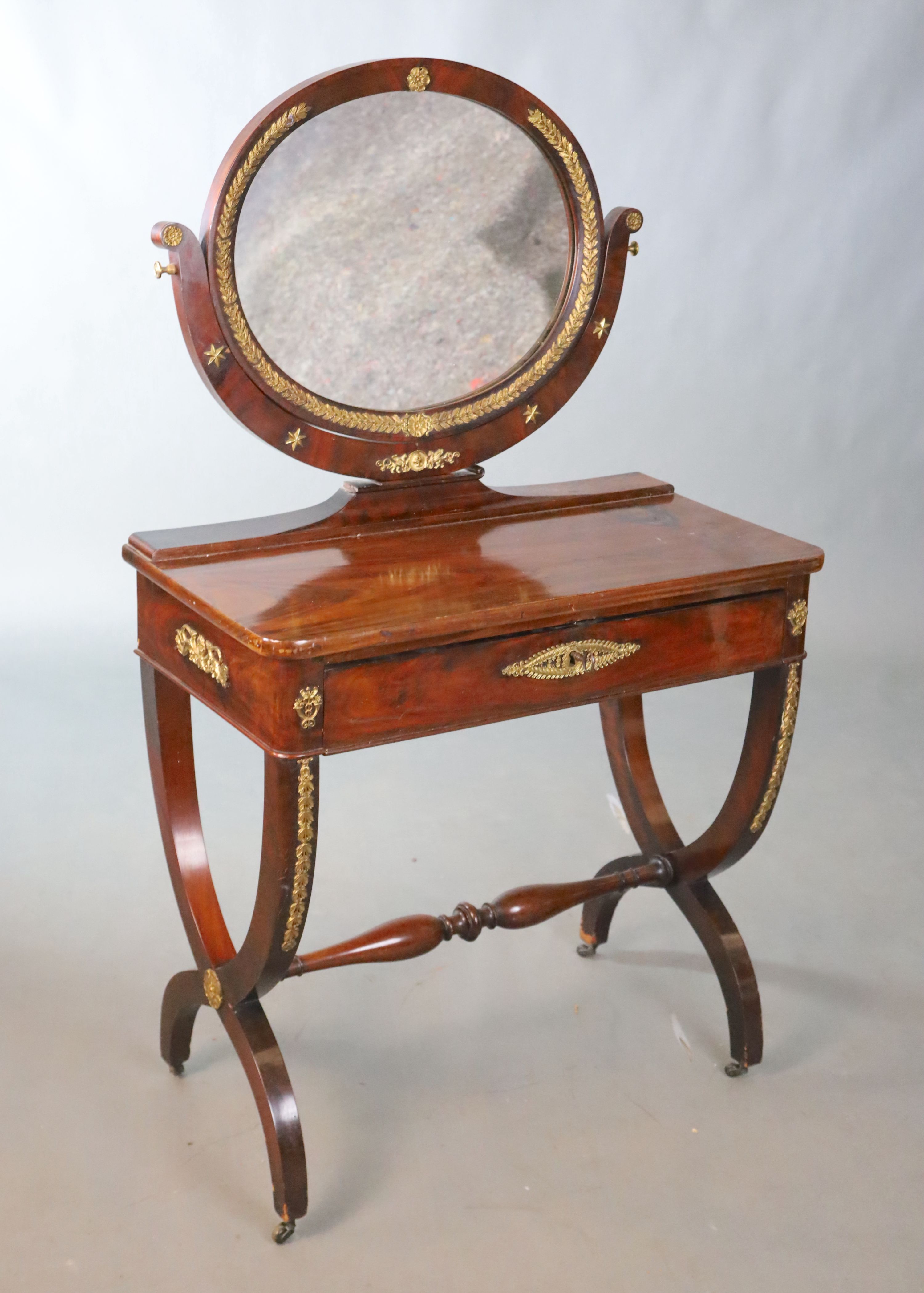 A Restauration gilt-bronze mounted mahogany dressing table, retailers stamp Edwards & Roberts, W.81.5cm D.42cm H.140cm